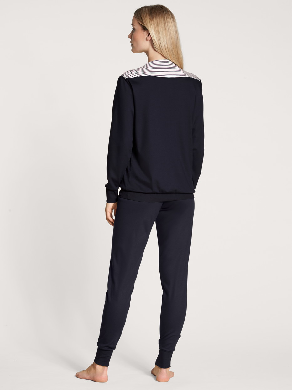 Women model is wearing Pyjama with cuff made of 100% Cotton in Blue, Unicoloured from the Soulmate series by CALIDA, Back view