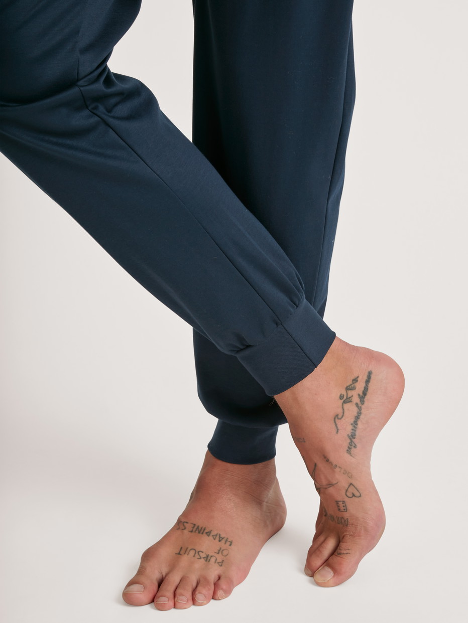 Herren-Model trägt Bündchen-Pyjama aus 100% Baumwolle in Blau, Motiv aus Serie Relax Selected 6 von CALIDA, Detail