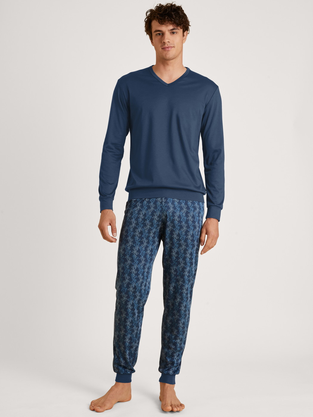 Men model is wearing Pyjama with cuff made of 100% Cotton in Blue, Patterned from the Nightwear Xtra series by CALIDA, Front view