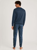 Men model is wearing Pyjama with cuff made of 100% Cotton in Blue, Patterned from the Nightwear Xtra series by CALIDA, Back view