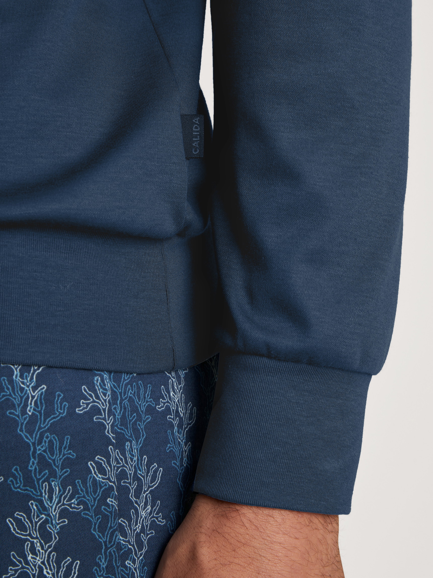 Men model is wearing Pyjama with cuff made of 100% Cotton in Blue, Patterned from the Nightwear Xtra series by CALIDA, Detail