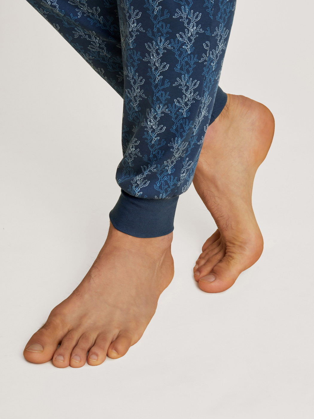 Men model is wearing Pyjama with cuff made of 100% Cotton in Blue, Patterned from the Nightwear Xtra series by CALIDA, Detail