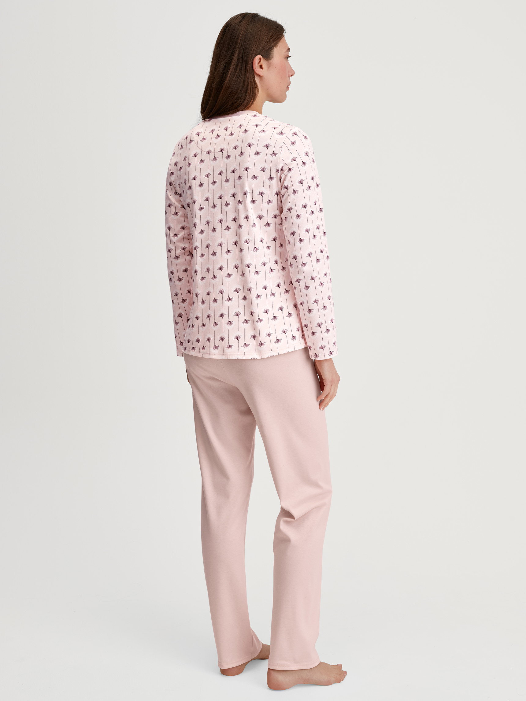 Women model is wearing Pyjamas, long made of 100% Cotton in Pink, Floral from the Midnight Flowers series by CALIDA, Back view