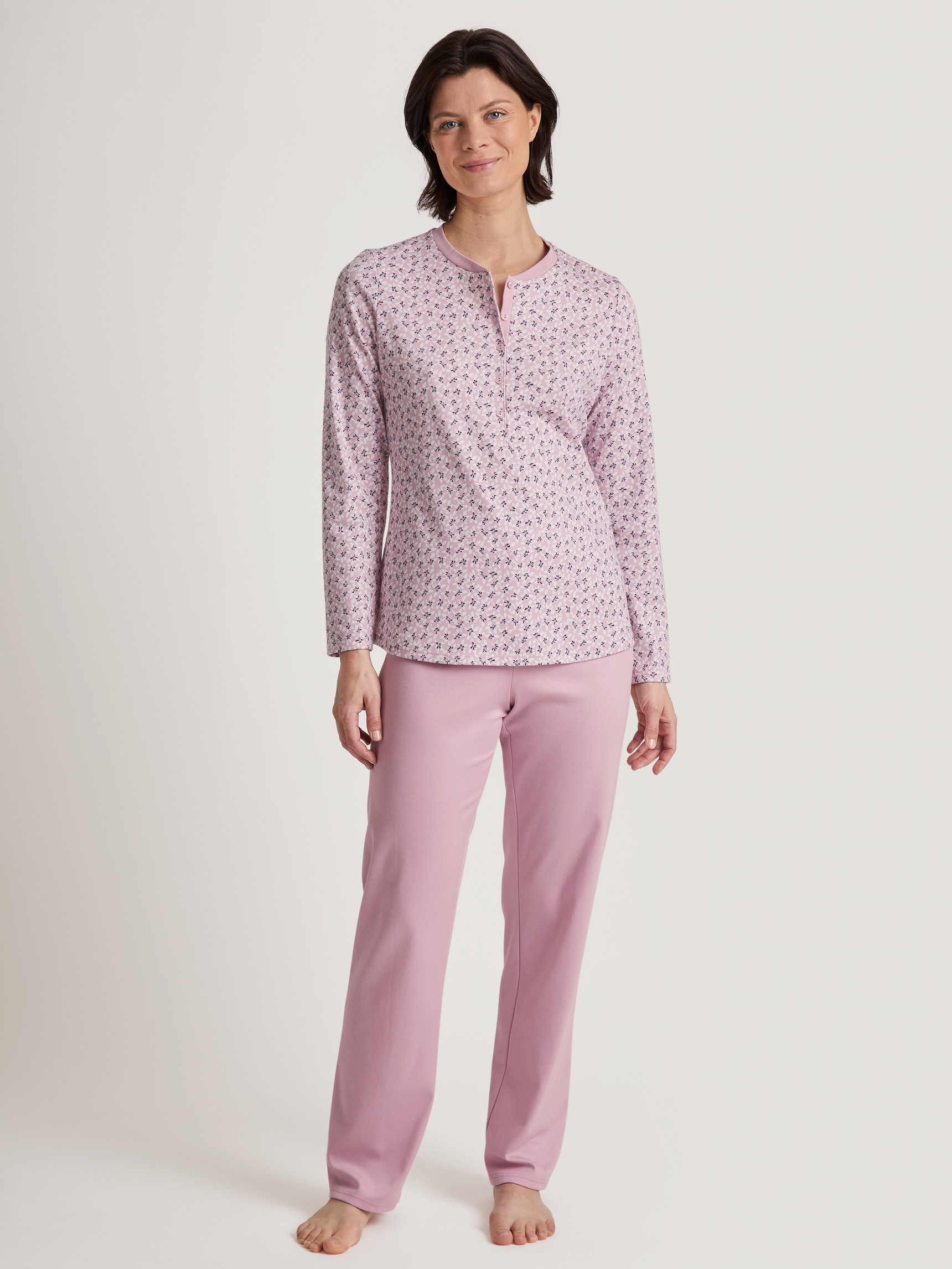 Women model is wearing Pyjamas, long made of 100% Cotton in Purple, Floral from the Midnight Flowers series by CALIDA, Front view