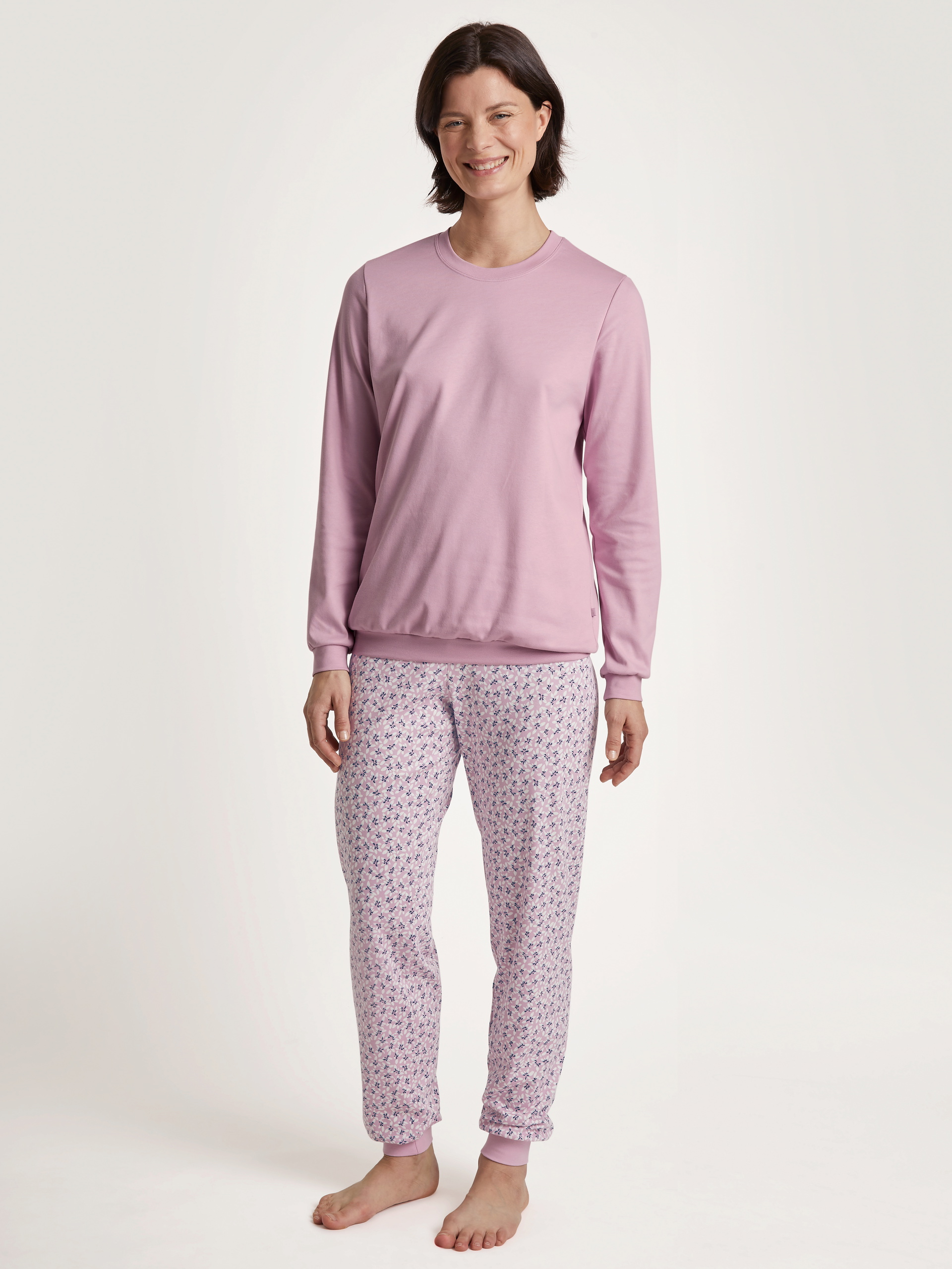 Women model is wearing Pyjama with cuff made of 100% Cotton in Purple, Floral from the Midnight Flowers series by CALIDA, Front view