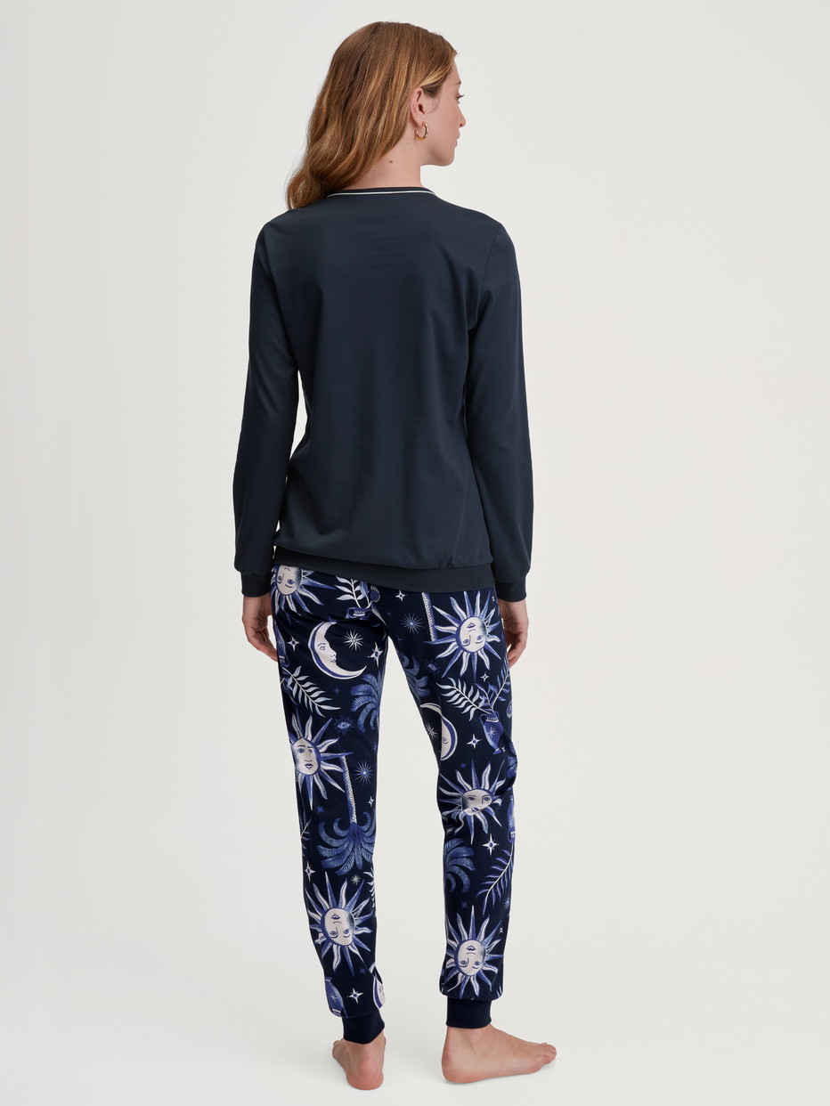 Women model is wearing Pyjama with cuff made of 100% Cotton in Blue, Patterned from the Winter Dreams series by CALIDA, Back view
