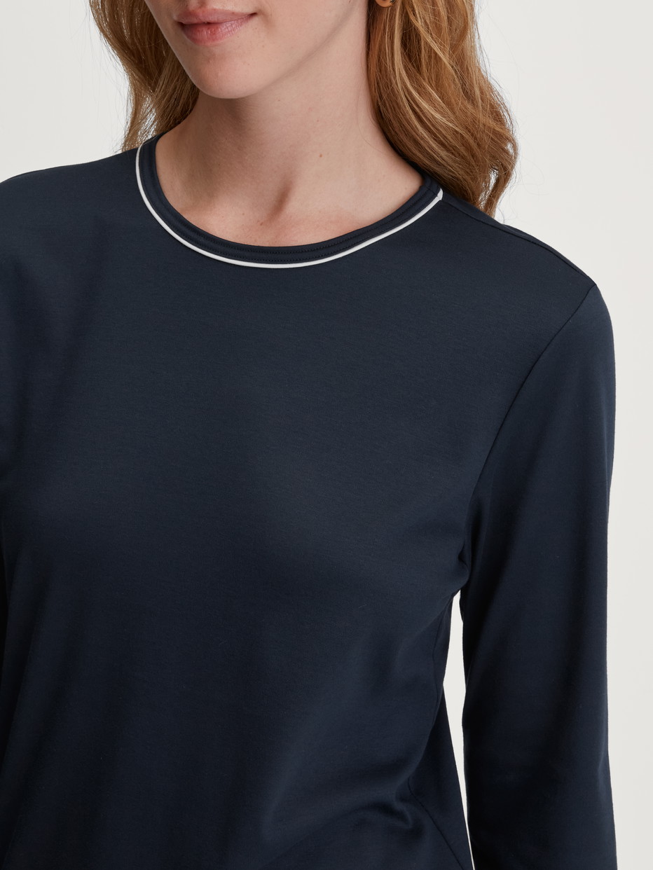 Women model is wearing Pyjama with cuff made of 100% Cotton in Blue, Patterned from the Winter Dreams series by CALIDA, Detail