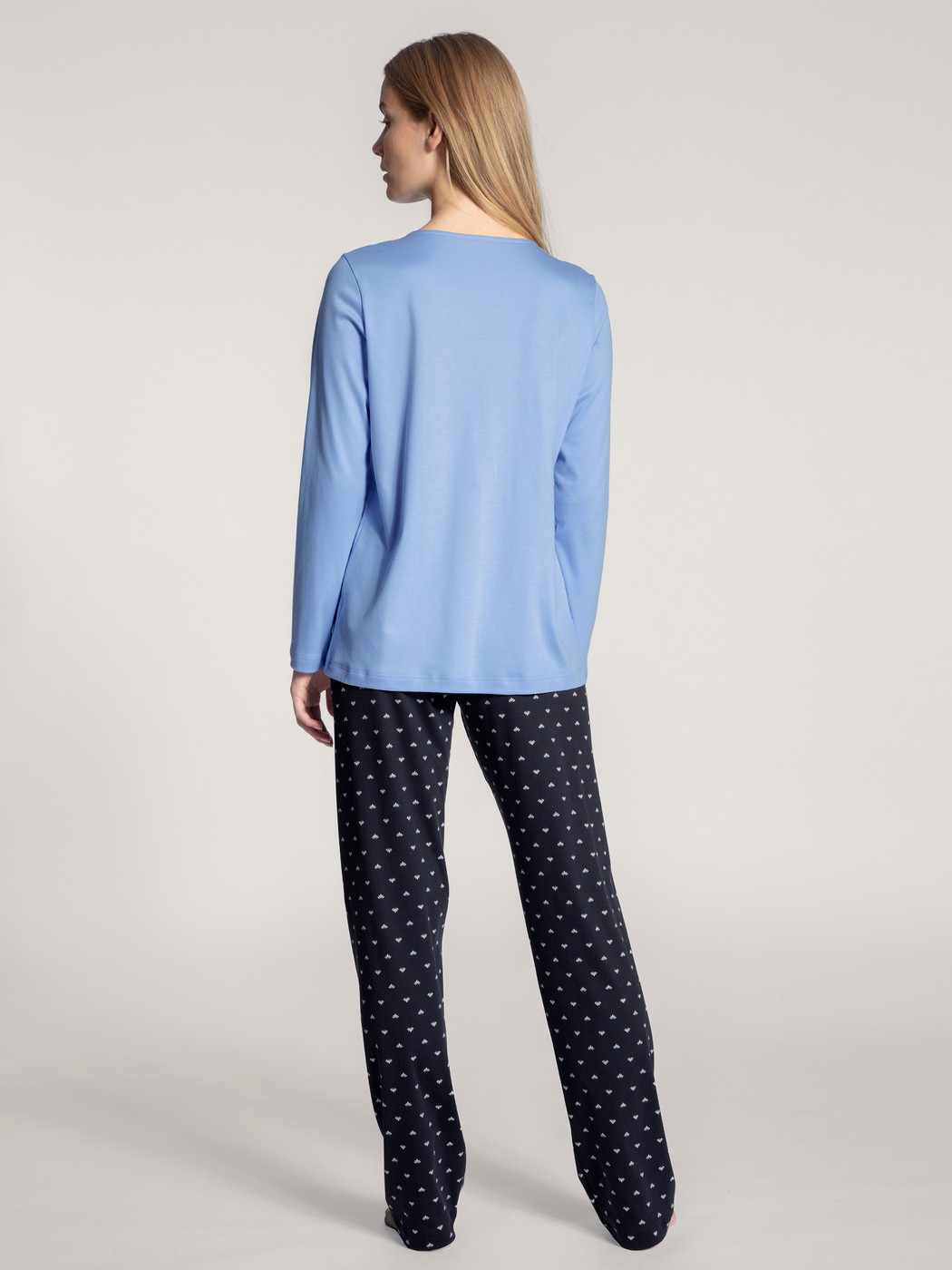 Women model is wearing Pyjama made of 100% Cotton in Blue, Motif from the Night Lovers series by CALIDA, Back view