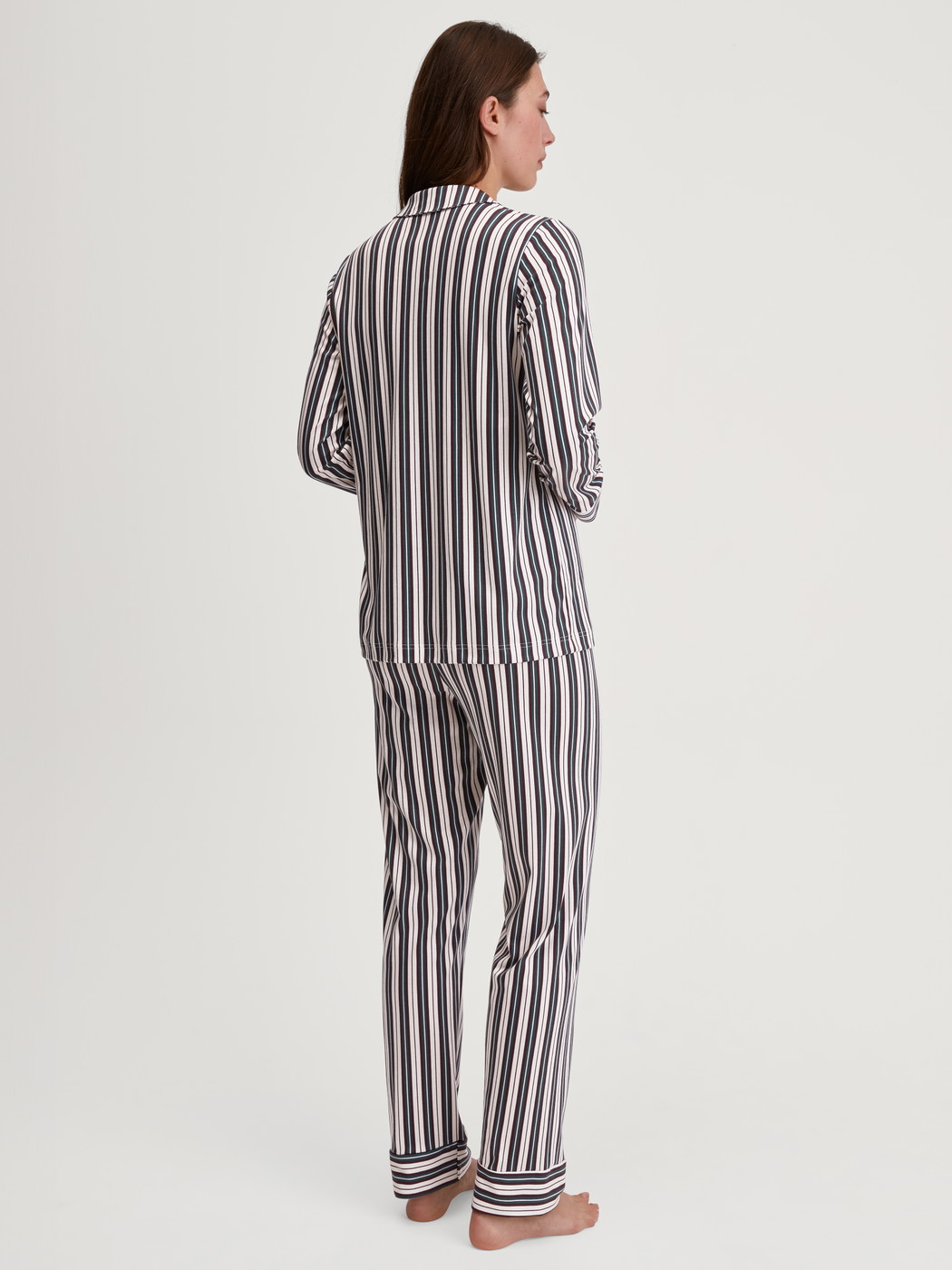 Women model is wearing Button-Up Pyjama made of 100% Cotton in Green, Striped from the Night Lovers series by CALIDA, Back view