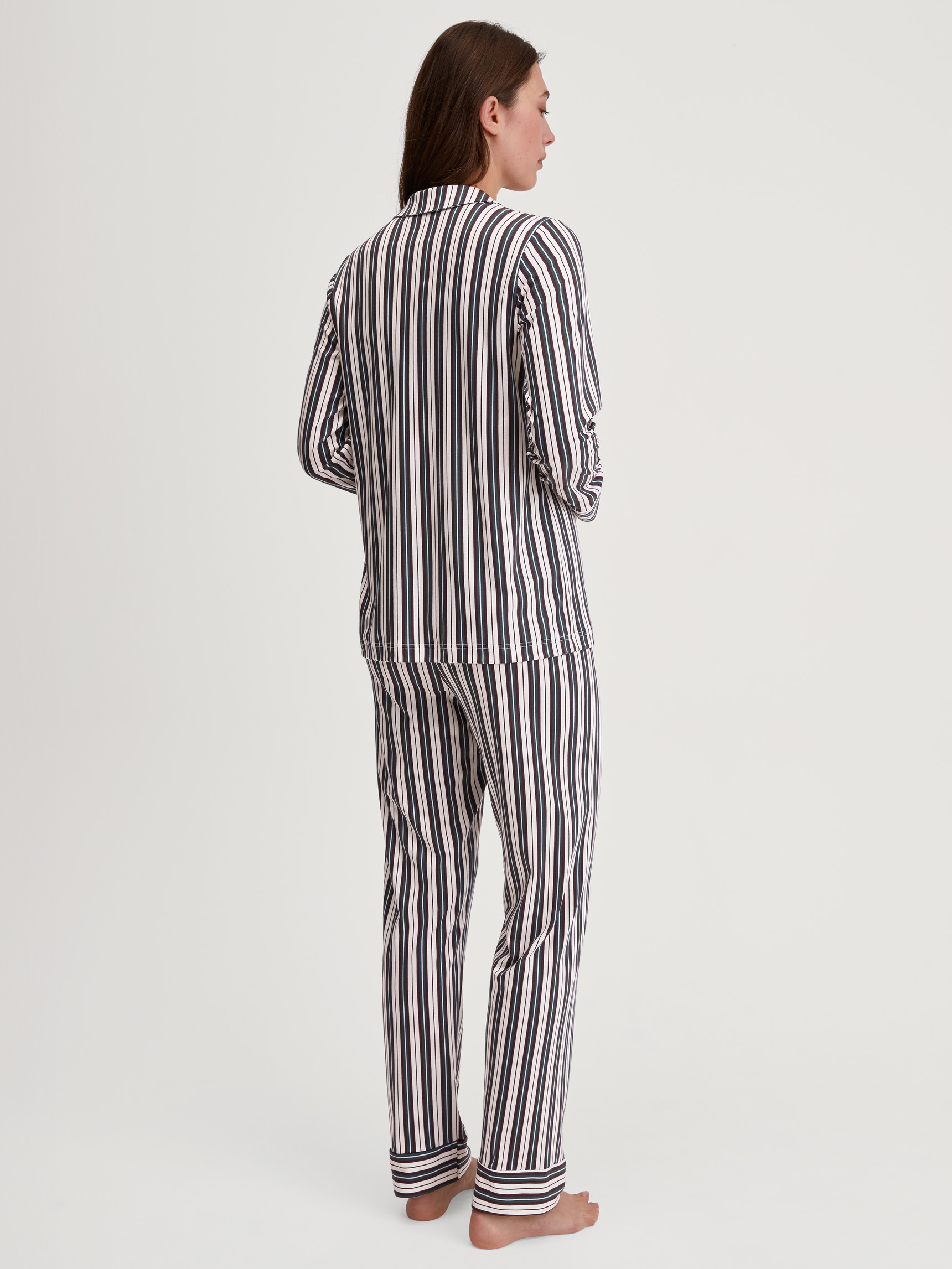 Women model is wearing Button-Up Pyjama made of 100% Cotton in Green, Striped from the Night Lovers series by CALIDA, Back view