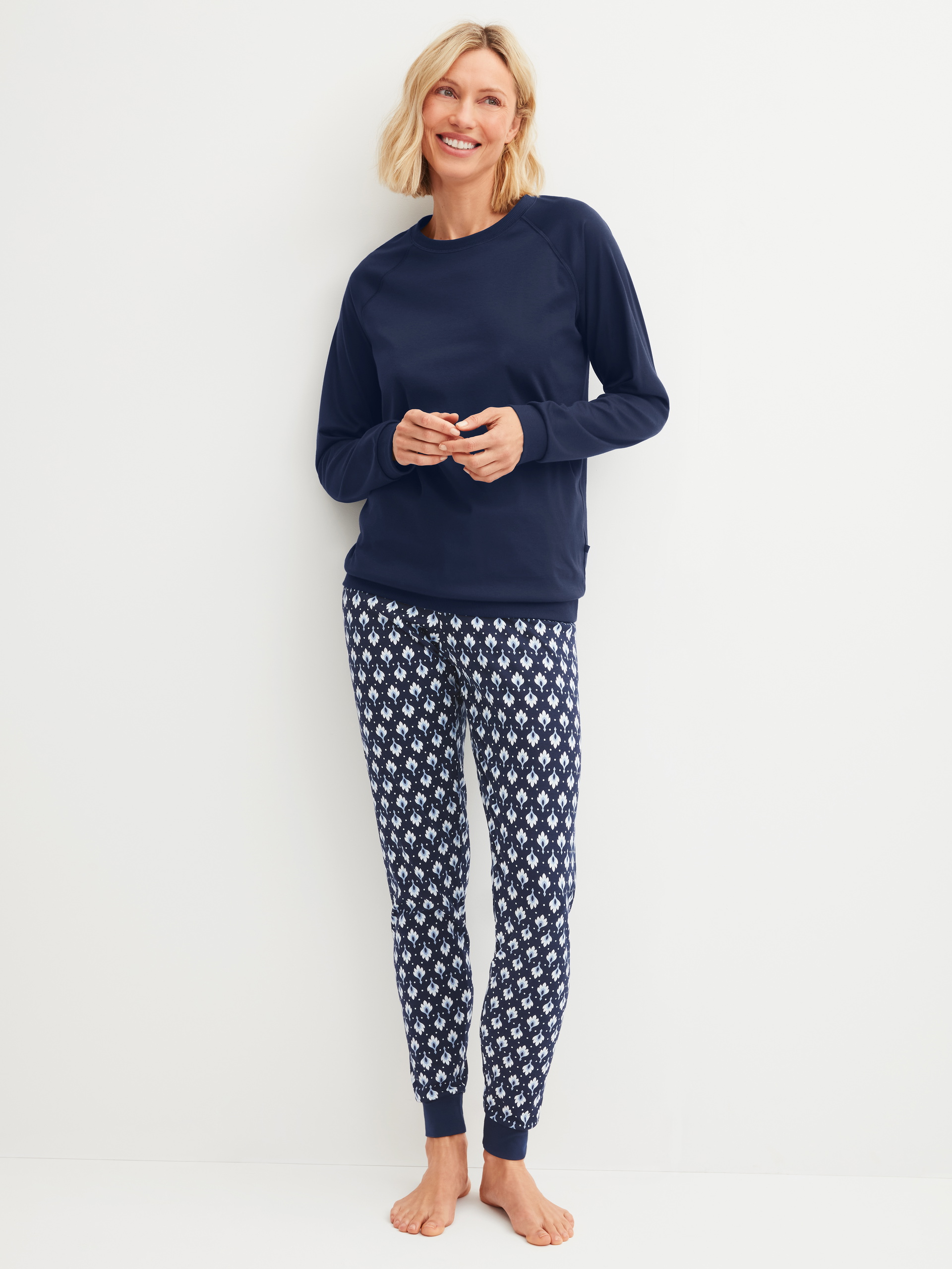 Women model is wearing Pyjama with cuff made of 100% Cotton in Blue, Patterned from the Daylight Dreams series by CALIDA, Front view