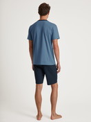 Men model is wearing Short pyjama made of 100% Cotton in Blue, Unicoloured from the Relax Essentials series by CALIDA, Back view