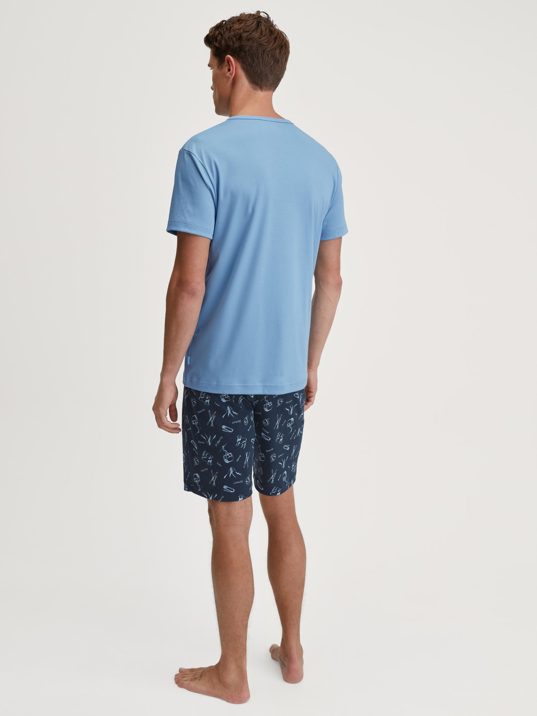 Men model is wearing Short pyjamas made of 100% Cotton in Blue, Patterned from the Relax Swiss Resort series by CALIDA, Back view