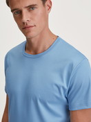 Men model is wearing Short pyjamas made of 100% Cotton in Blue, Patterned from the Relax Swiss Resort series by CALIDA, Detail