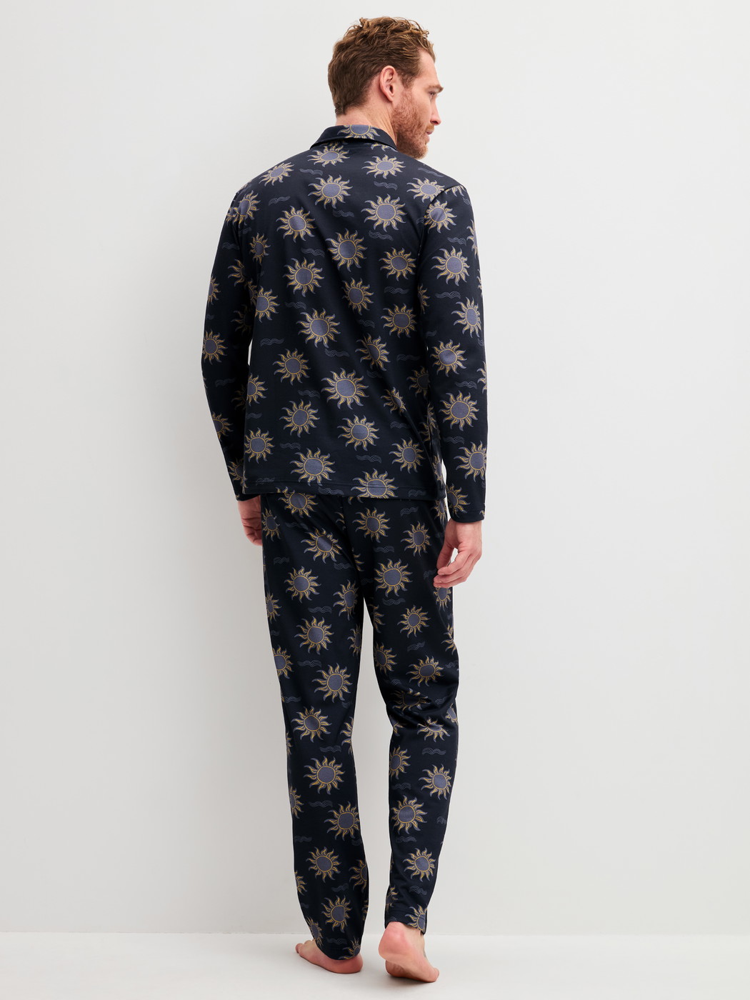 Men model is wearing Button-Up Pyjama made of 100% Cotton in Blue, Patterned from the EDITION 85 series by CALIDA, Back view
