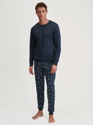 Men model is wearing Pyjama with cuff made of 100% Cotton in Blue, Patterned from the Relax Swiss Resort series by CALIDA, Front view