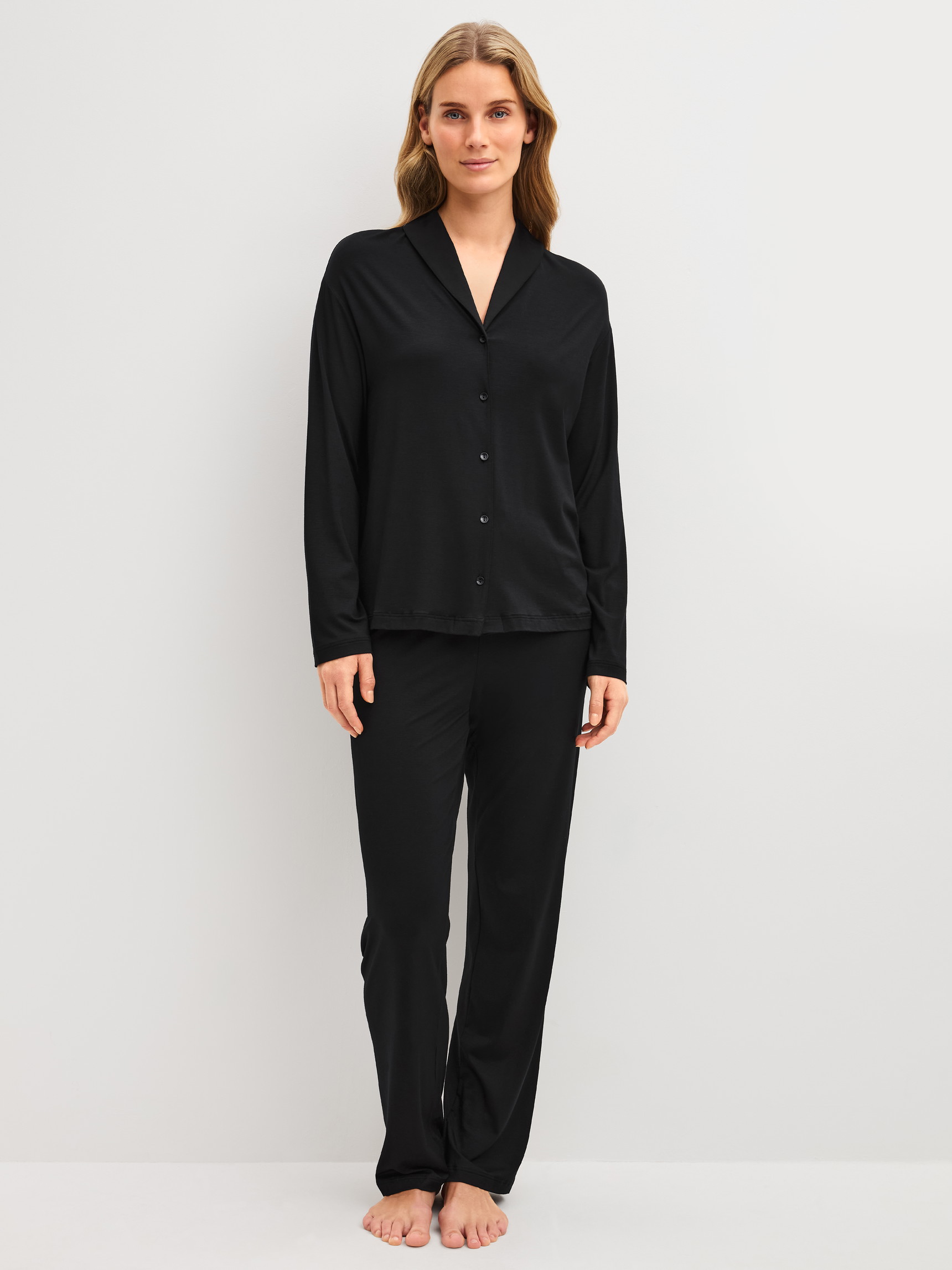 Women model is wearing Button-Up Pyjama made of Modal in Black, Unicoloured from the Balancing Dreams series by CALIDA, Front view