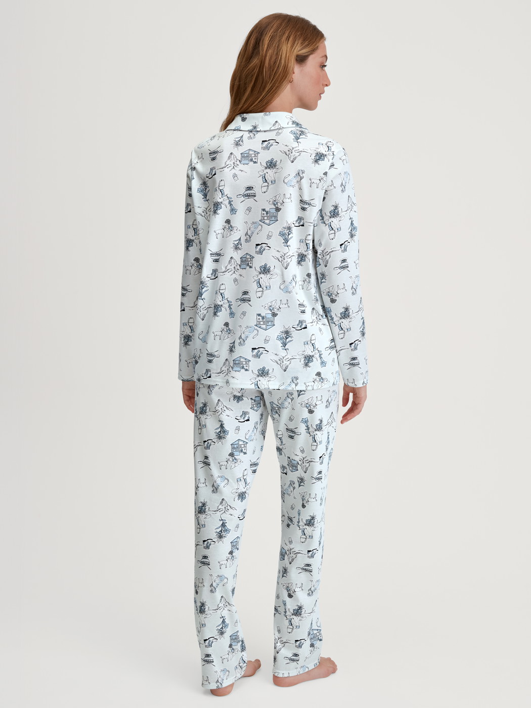 Women model is wearing Button-Up Pyjama made of 100% Cotton in Blue, Patterned from the Swiss Resort series by CALIDA, Back view