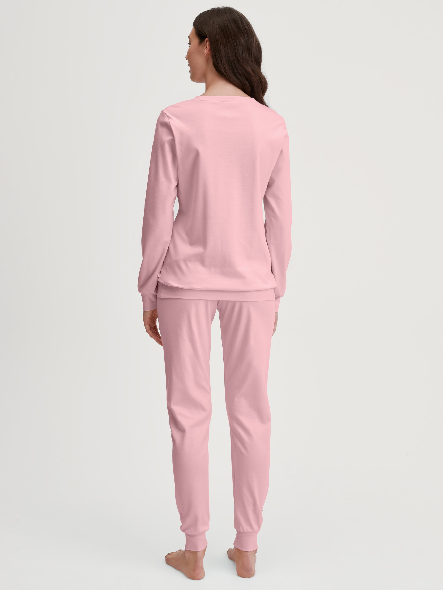 Women model is wearing Pyjama with cuff made of 100% Cotton in Pink, Motif from the Ski Resort series by CALIDA, Back view