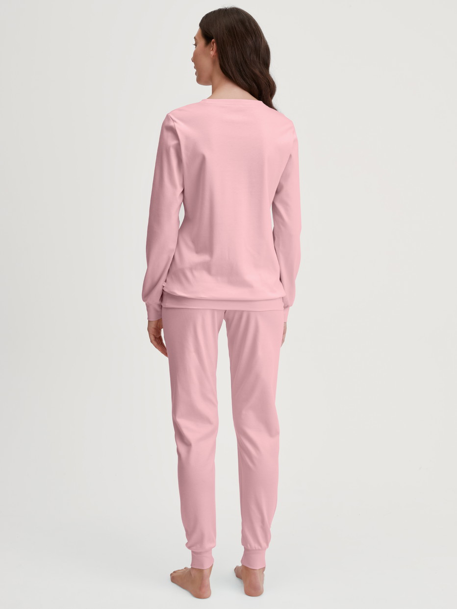 Women model is wearing Pyjama with cuff made of 100% Cotton in Pink, Motif from the Ski Resort series by CALIDA, Back view