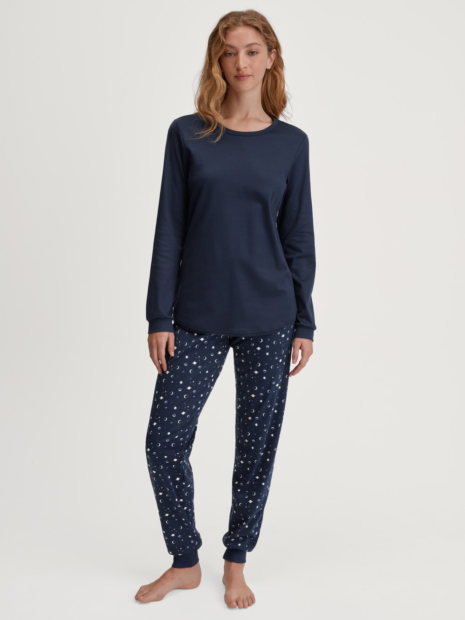 Women model is wearing Pyjama with cuff made of 100% Cotton in Blue, Patterned from the Midnight Dreams series by CALIDA, Front view