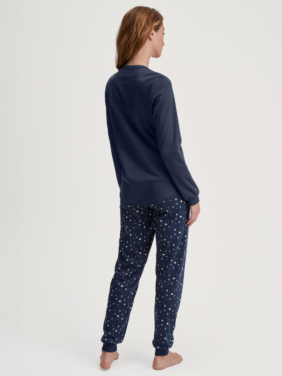 Women model is wearing Pyjama with cuff made of 100% Cotton in Blue, Patterned from the Midnight Dreams series by CALIDA, Back view