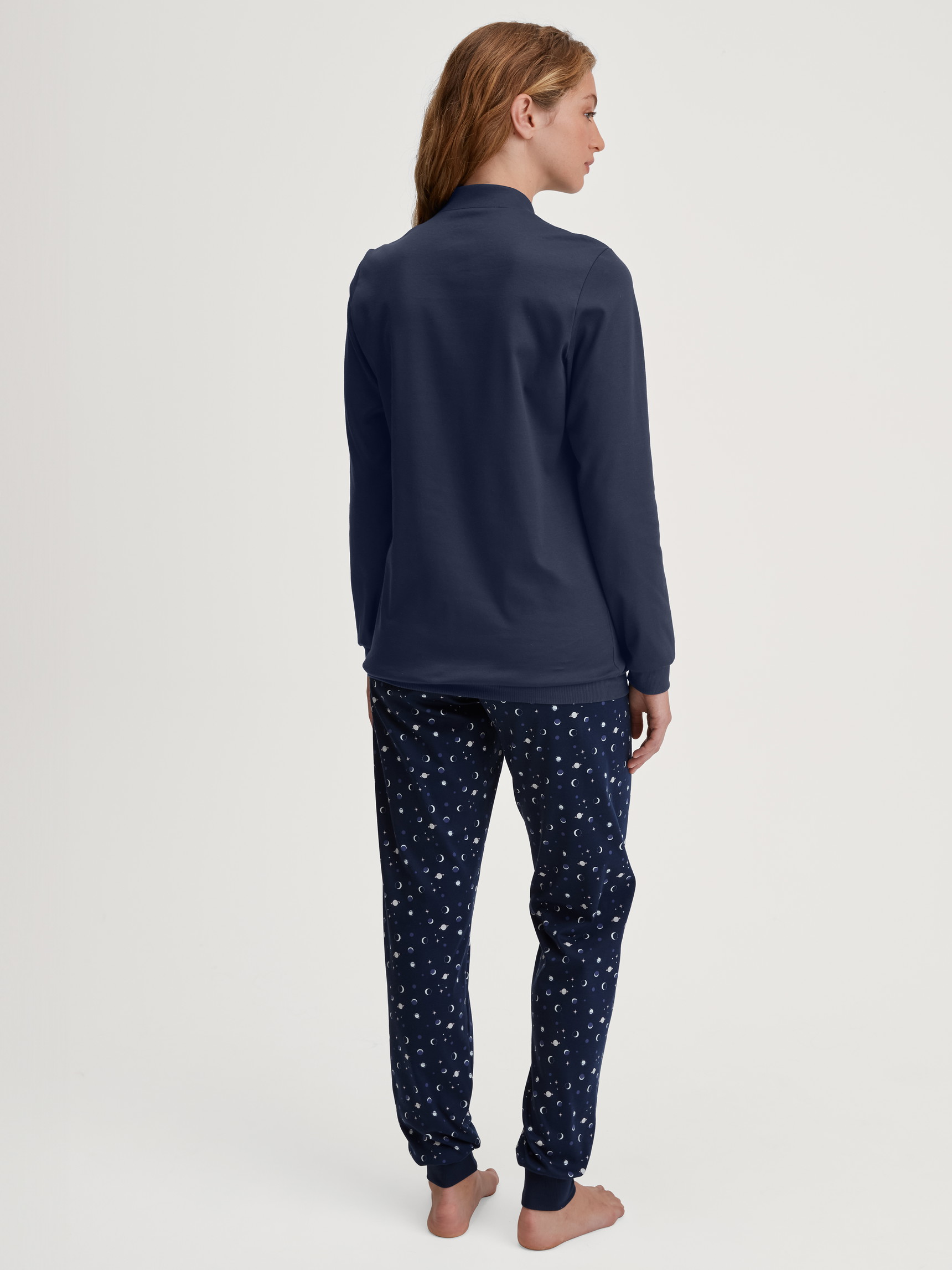 Women model is wearing Pyjama with cuff made of 100% Cotton in Blue, Patterned from the Midnight Dreams series by CALIDA, Back view