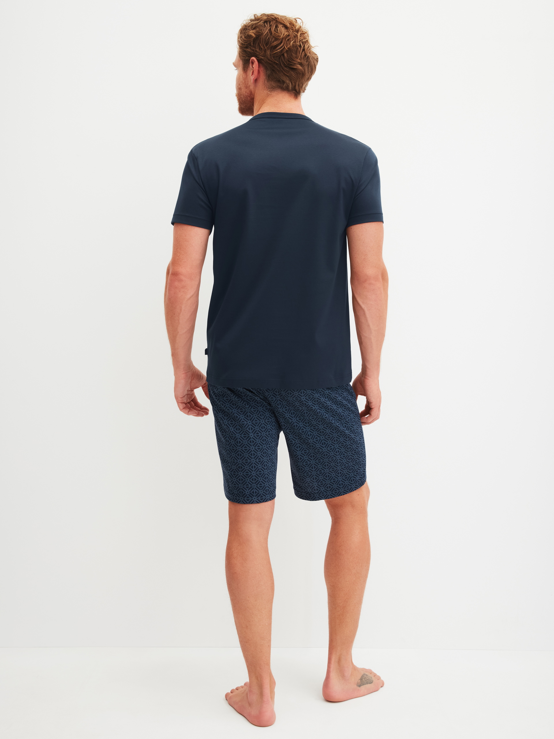 Men model is wearing Short pyjama made of 100% Cotton in Blue, Patterned from the Relax Selected 2 series by CALIDA, Back view