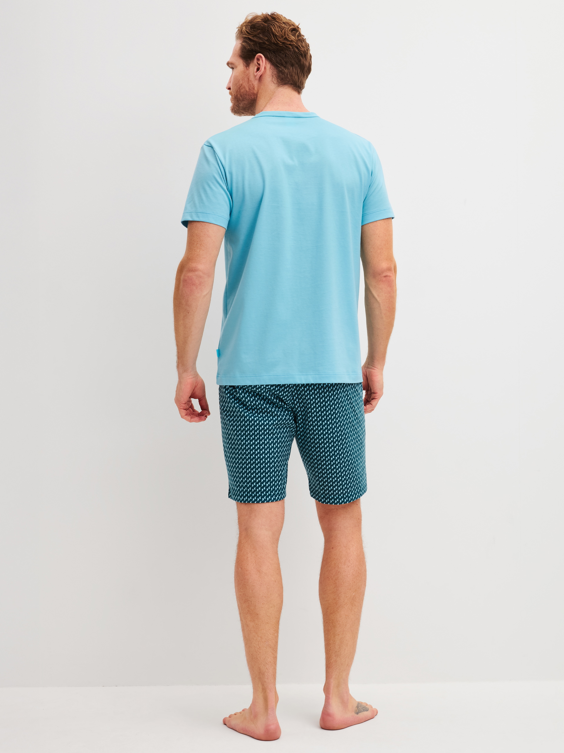 Men model is wearing Short pyjama made of 100% Cotton in Blue, Patterned from the Cotton Special series by CALIDA, Back view