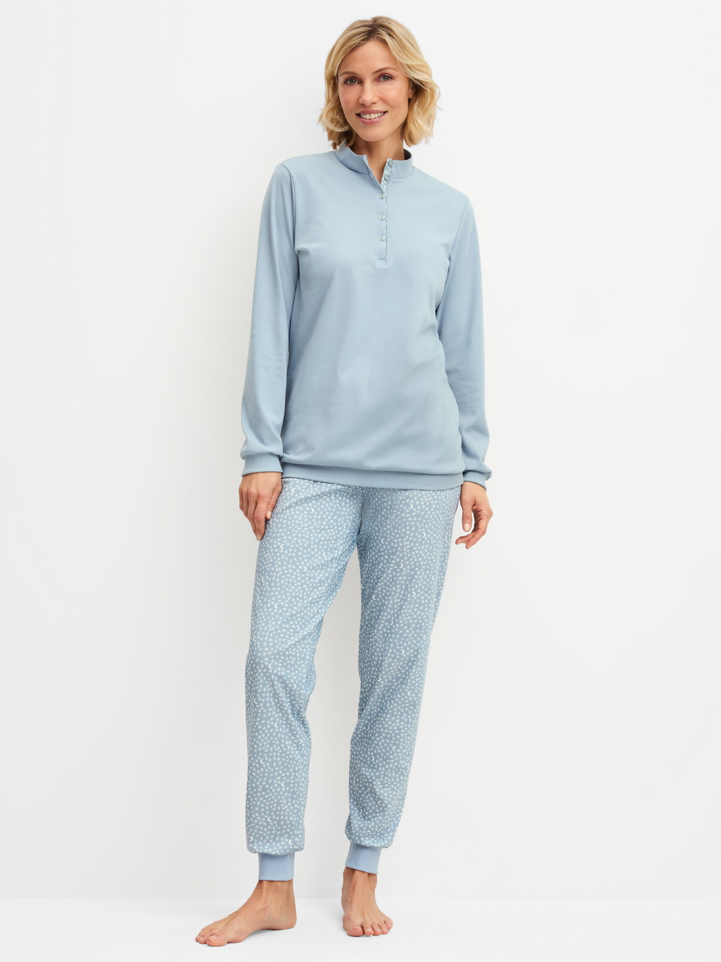 Women model is wearing Ribbed Cuff Pyjamas made of 100% Cotton in Blue, Patterned from the Midnight Dreams series by CALIDA, Front view