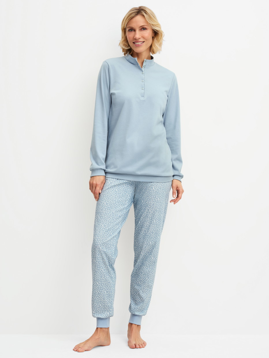 Women model is wearing Ribbed Cuff Pyjamas made of 100% Cotton in Blue, Patterned from the Midnight Dreams series by CALIDA, Front view