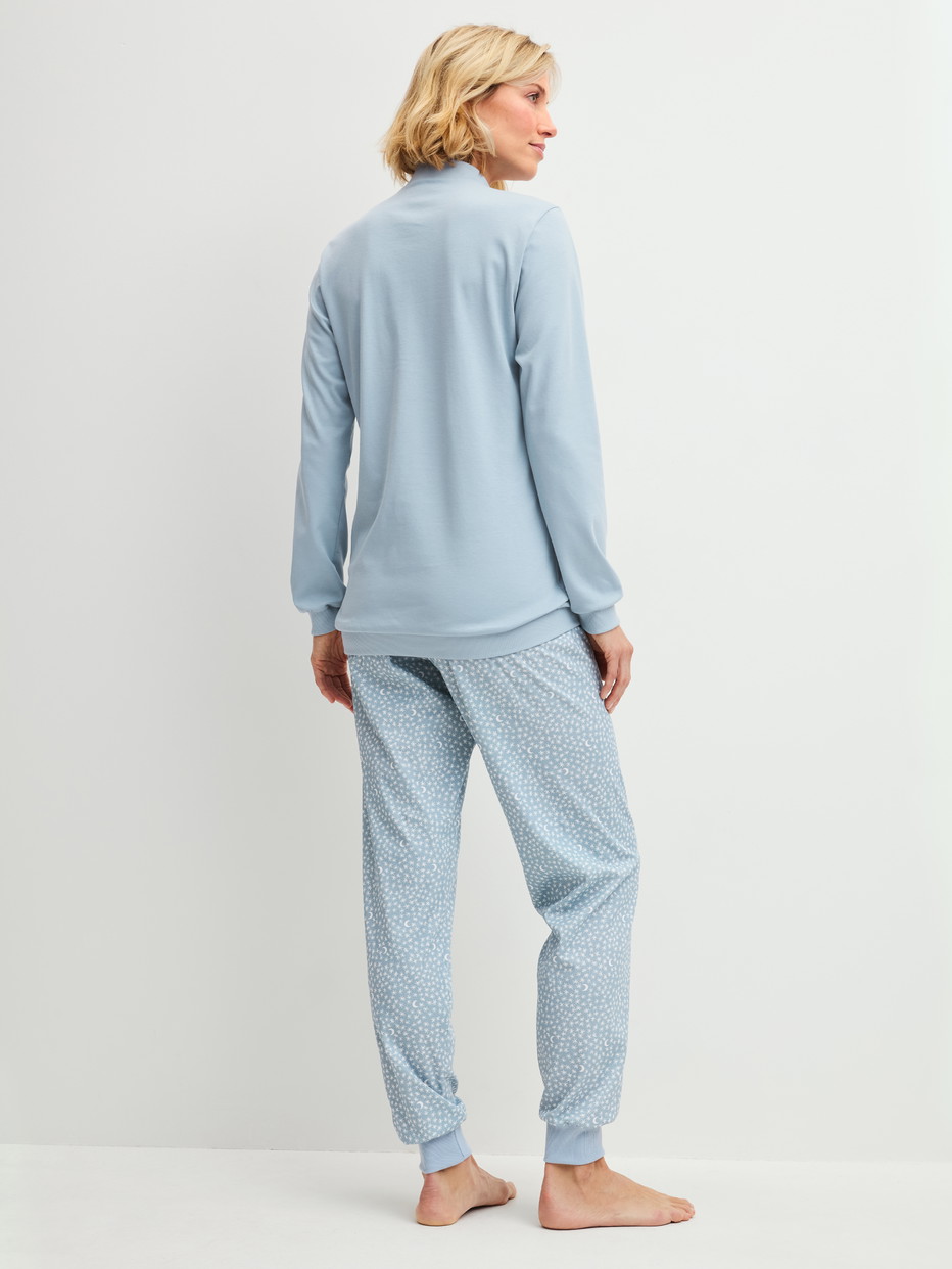 Women model is wearing Ribbed Cuff Pyjamas made of 100% Cotton in Blue, Patterned from the Midnight Dreams series by CALIDA, Back view