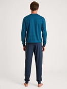 Men model is wearing Pyjama with cuff made of 100% Cotton in Turquoise, Patterned from the Nightwear Xtra series by CALIDA, Back view