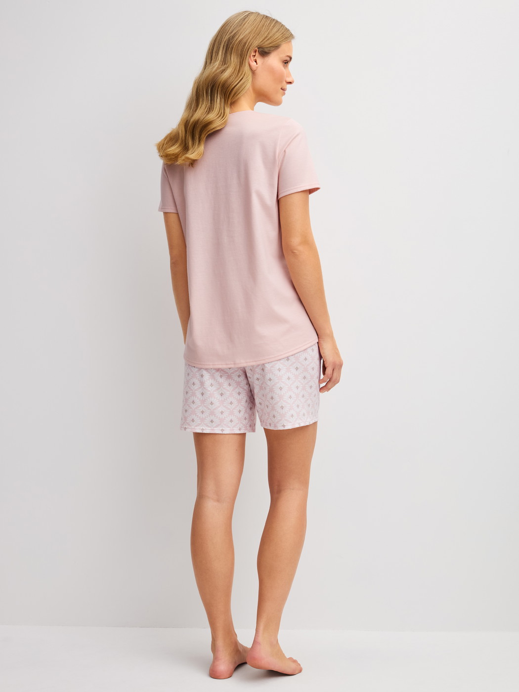 Women model is wearing Short pyjamas made of 100% Cotton in Pink, Floral from the Cotton Special series by CALIDA, Back view