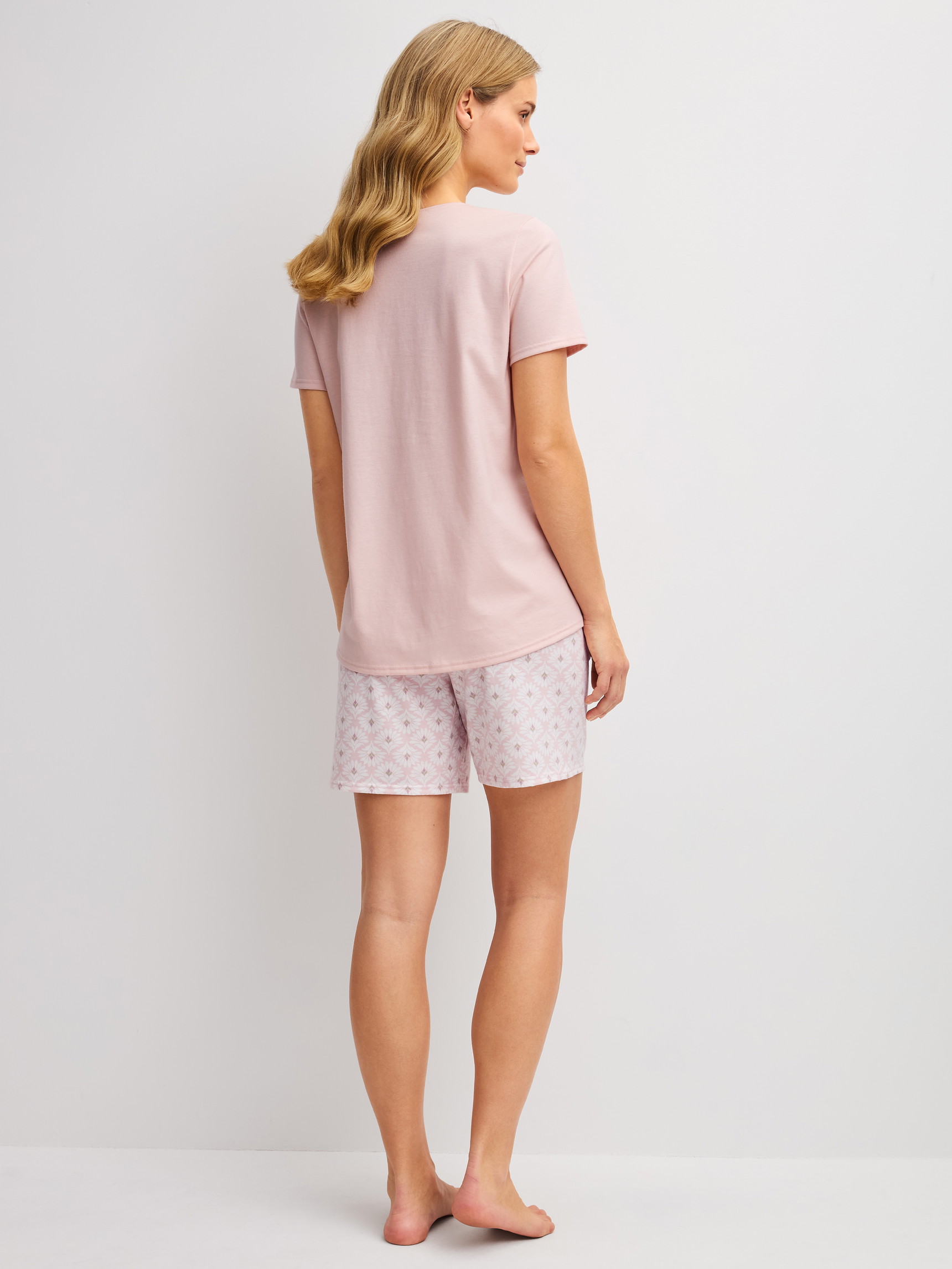Women model is wearing Short pyjamas made of 100% Cotton in Pink, Floral from the Cotton Special series by CALIDA, Back view