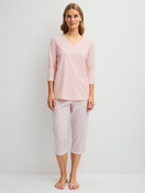 Women model is wearing Capri Pyjama made of 100% Cotton in Pink, Floral from the Cotton Special series by CALIDA, Front view