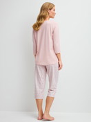 Women model is wearing Capri Pyjama made of 100% Cotton in Pink, Floral from the Cotton Special series by CALIDA, Back view