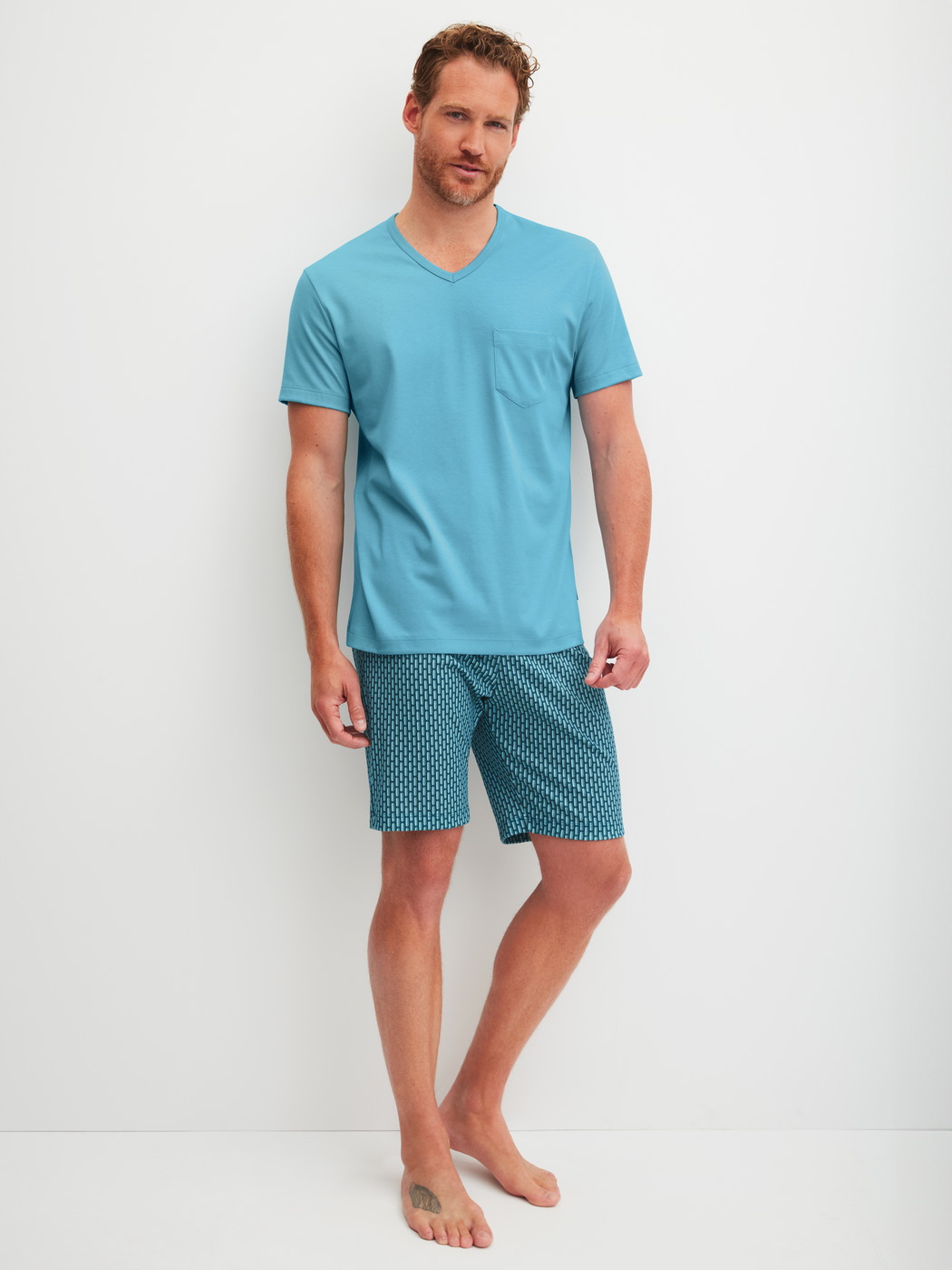 Men model is wearing Short pyjamas made of 100% Cotton in Blue, Patterned from the Relax Streamline 1 series by CALIDA, Front view