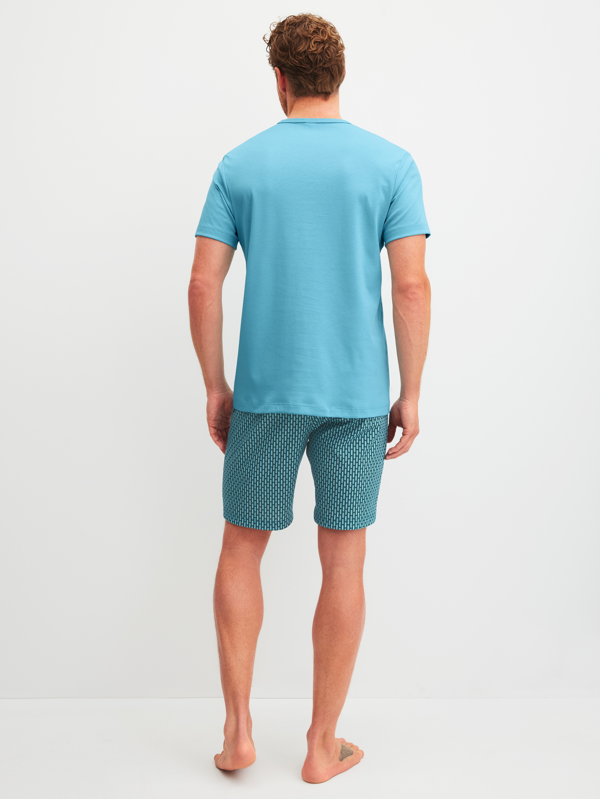 Men model is wearing Short pyjamas made of 100% Cotton in Blue, Patterned from the Relax Streamline 1 series by CALIDA, Back view