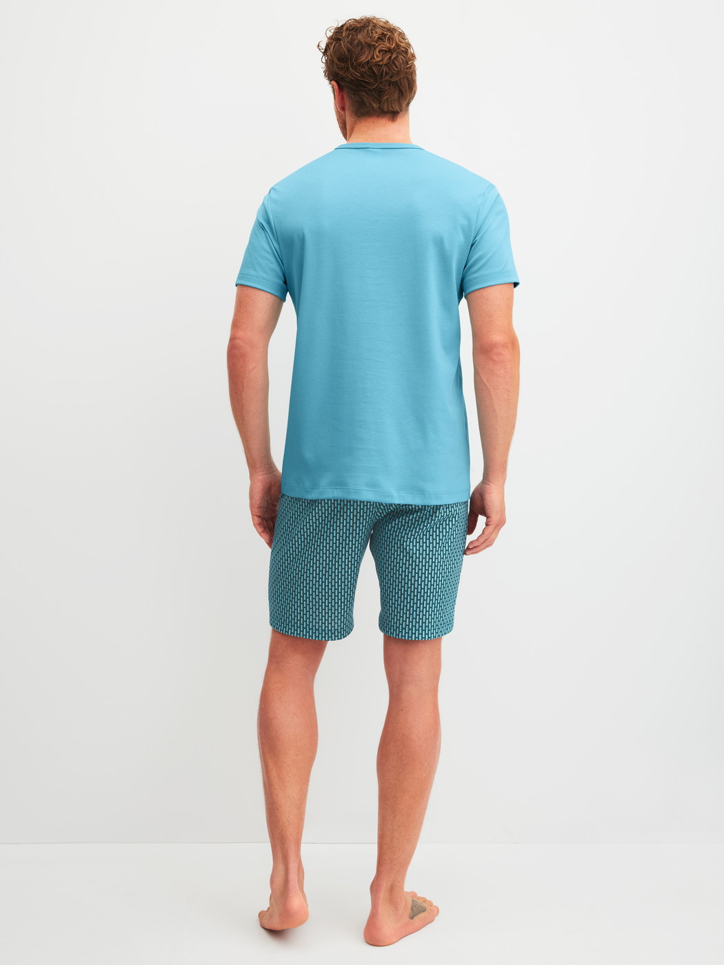 Men model is wearing Short pyjamas made of 100% Cotton in Blue, Patterned from the Relax Streamline 1 series by CALIDA, Back view