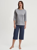 Women model is wearing Capri Pyjama made of 100% Cotton in Blue, Patterned from the Cotton Special series by CALIDA, Front view