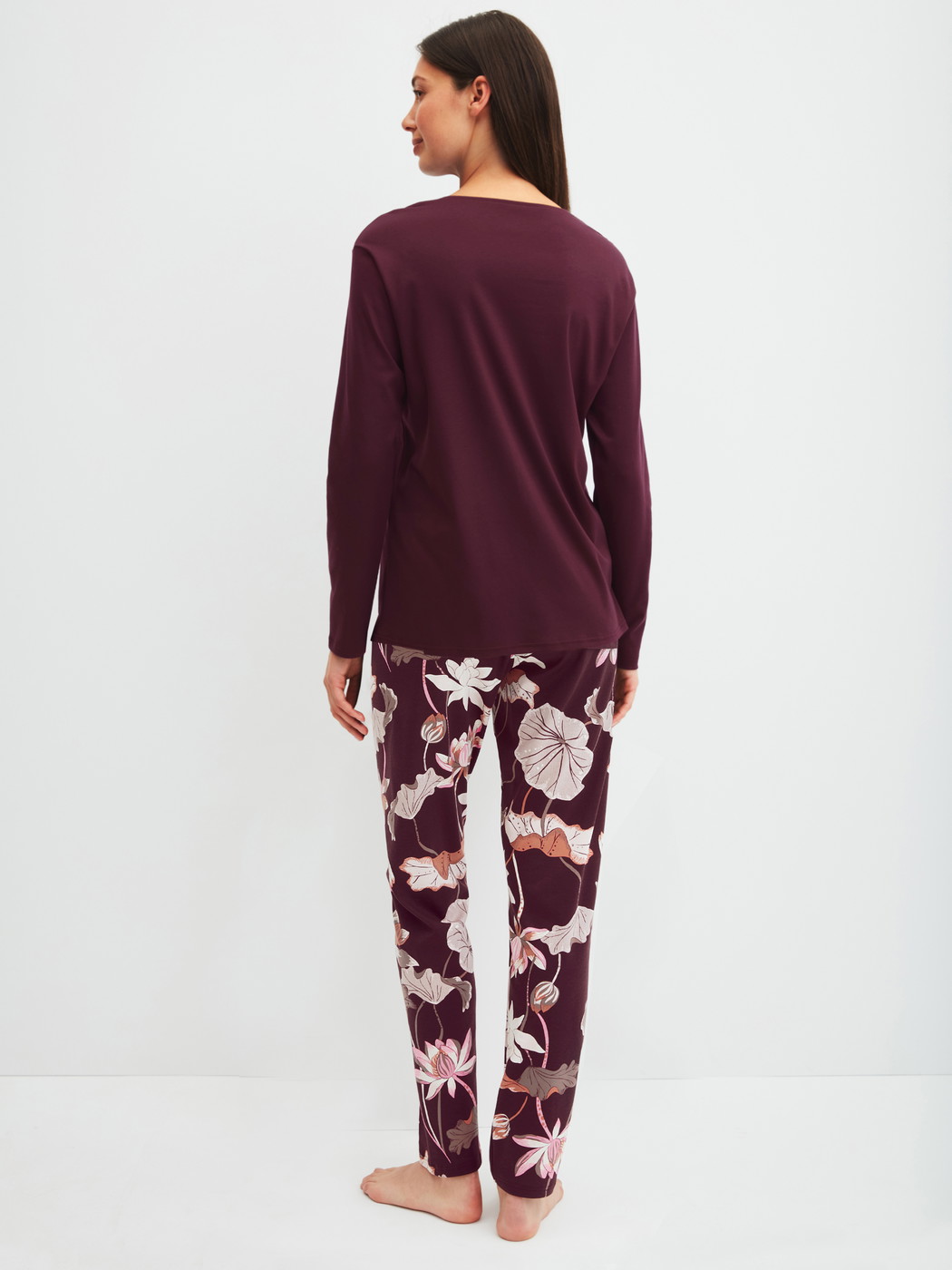 Women model is wearing Pyjamas, long made of 100% Cotton in Red, Floral from the Season Special series by CALIDA, Back view