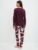 Women model is wearing Pyjamas, long made of 100% Cotton in Red, Floral from the Season Special series by CALIDA, Back view