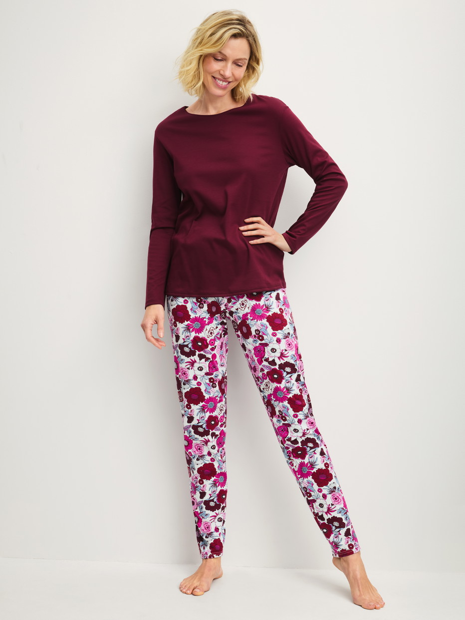 Women model is wearing Pyjamas, long made of 100% Cotton in Red, Patterned from the Season Special series by CALIDA, Front view