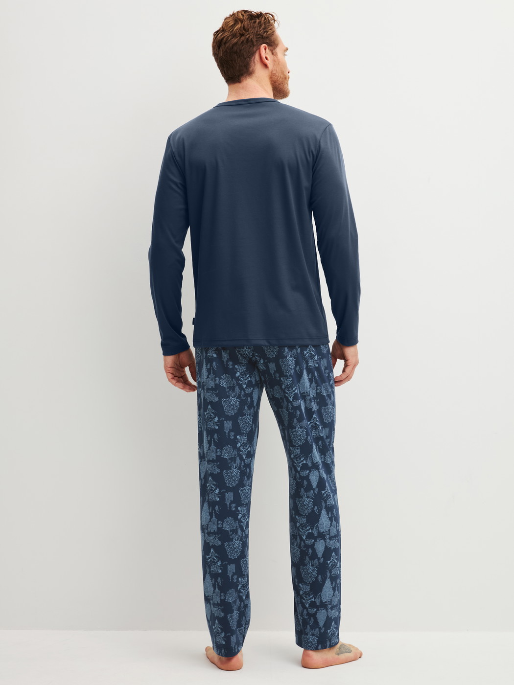 Men model is wearing Pyjamas, long made of 100% Cotton in Blue, Patterned from the Relax Streamline 1 series by CALIDA, Back view