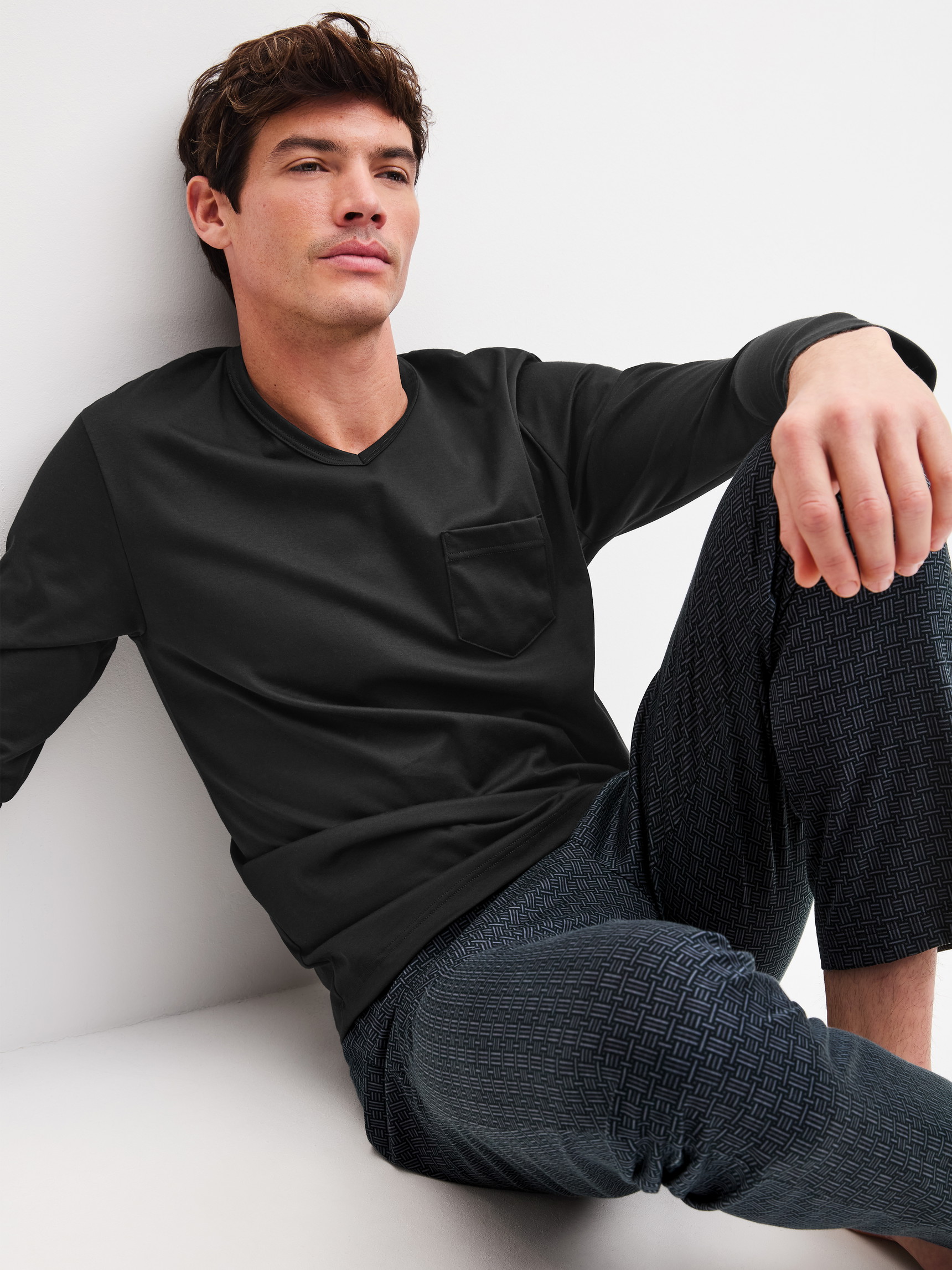 Men model is wearing Pyjamas, long made of 100% Cotton in Black, Patterned from the Relax Streamline 2 series by CALIDA, Front view