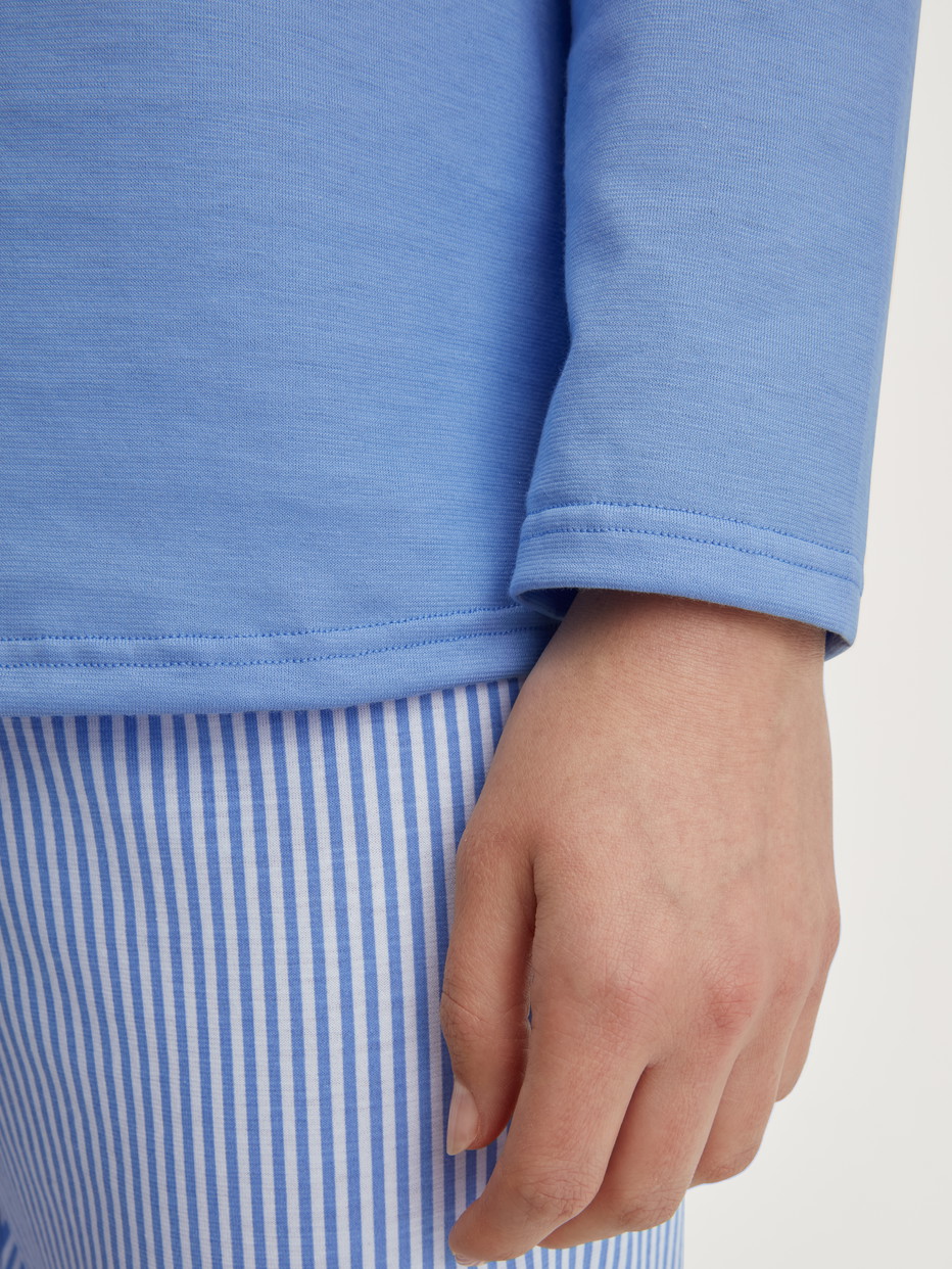 Women model is wearing Pyjamas, long made of 100% Cotton in Blue, Patterned from the Lovely Nights series by CALIDA, Detail