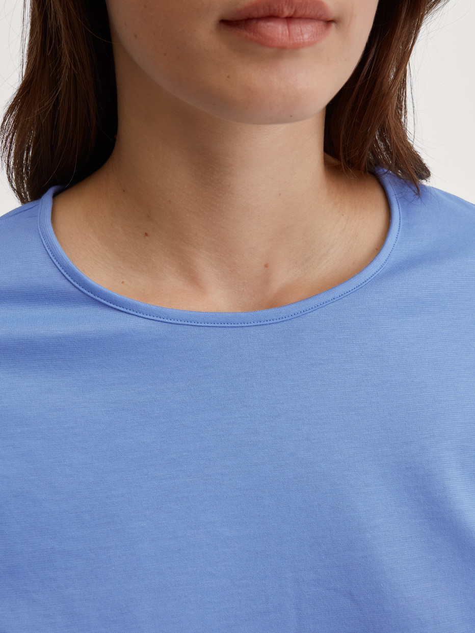 Women model is wearing Pyjamas, long made of 100% Cotton in Blue, Patterned from the Lovely Nights series by CALIDA, Detail