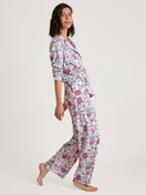 Women model is wearing Button-Up Pyjama made of 100% Cotton in Purple, Floral from the Spring Flower Dreams series by CALIDA