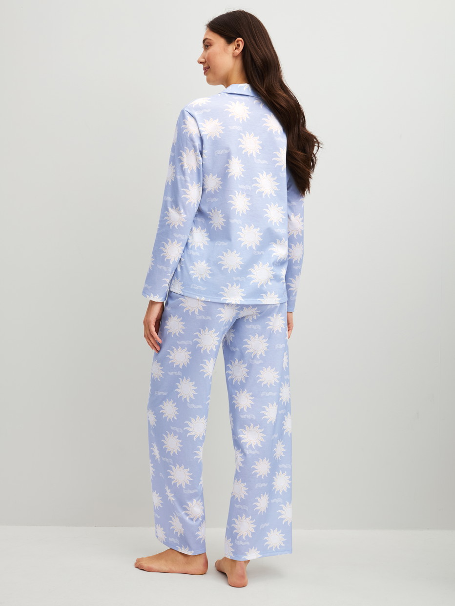 Women model is wearing Button-Up Pyjama made of 100% Cotton in Blue, Patterned from the EDITION 85 series by CALIDA, Back view